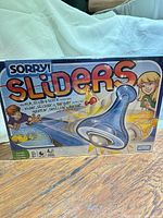 Front of sealed Sorry! Sliders box