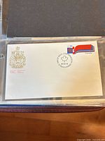 Full view of first day cover in sleeve with stamp, coat of arms and Ottawa cancel visible