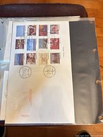 Front view of the full stamp sheet in protective sleeve