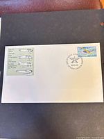Full view of First Day Cover envelope with 60¢ stamp and postmark