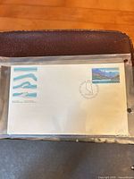 Full view of first day cover in sleeve showing stamp and cancel