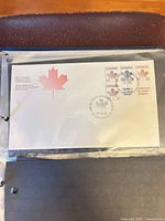 First day cover inside binder sleeve showing all four stamps and cancel
