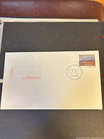 Full view of unopened first day cover showing stamp and cancel