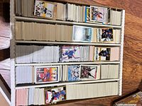 Three-row cardboard box densely filled with hockey trading cards viewed from top