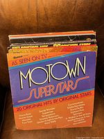 Front cover of Motown Superstars LP with additional records visible behind