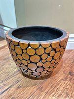 planter exterior showing wood slice mosaic