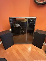 Cabinet flanked by two Sony speakers