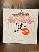 Front sleeve showing title graphics and sticker