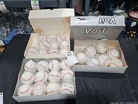 overview of three open boxes of baseballs