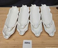 Top view of eight white ceramic corn-on-the-cob dishes