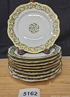 Stack of nine matching Limoges plates front view
