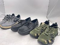 Three pairs of shoes side by side: Nike Air grey sneakers, Sperry grey boat shoes, green camouflage sneakers