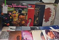 Front view showing Sesame Street, Paul Desmond and others in rack
