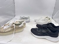 Four pairs women’s sneakers arranged together