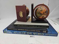 All items stacked: two globe bookends atop three books