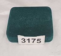 Green velour presentation box closed, Clarion Pell logo visible