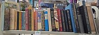 Full shelf of assorted books left to right
