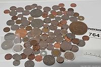 Overview of entire assortment of coins and tokens spread on surface