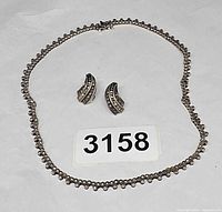 Full view of necklace and pair of earrings