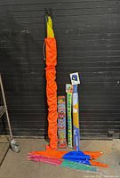 Group shot of all six kites upright, showing packaging and loose kites