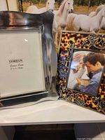 Both frames side by side on shelf