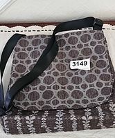 Front view of Maruca fabric handbag showing flap and strap