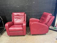 Front view of both red leather Natuzzi recliners