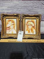 Front view showing both framed paintings side by side with size reference