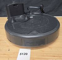 Top view of Roomba vacuum and charging dock showing overall condition