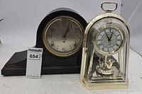 Front view of both clocks showing design and faces