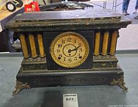 Front view of Seth Thomas mantel clock showing dial, missing glass, columns, feet
