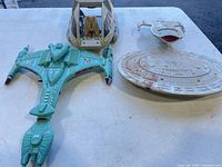 Three Star Trek starship toys: Klingon Bird-of-Prey, Danube-class runabout, incomplete USS Enterprise NCC-1701-D saucer