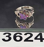 Ring front display showing star-shaped purple turquoise stone and band details