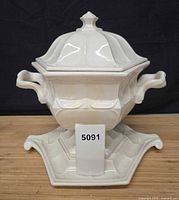 Complete tureen with lid on base, front view