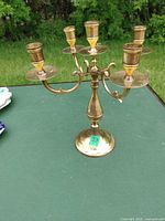 Overall view of brass five-arm candelabra standing on table