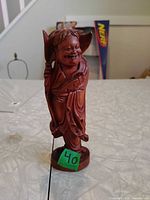 front view of carved wooden Laughing Buddha statue
