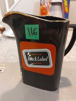 Front view showing Carling Black Label logo on black ceramic jug