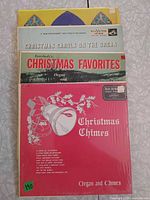Stack of four Christmas record albums showing titles and cover art
