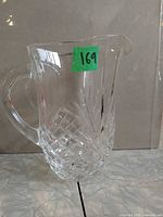 Full view of clear crystal pitcher showing handle and pattern