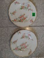 Both decorative floral Limoges plates front view