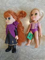 Front view of both dolls showing clothing, hair and overall condition