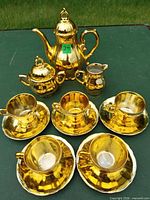 Full set laid out: teapot, sugar, creamer, cups, saucers