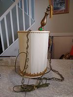 Full view of hanging lamp with fabric shade, chain, cord, wood finial