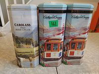 Front view of all three tins standing side by side