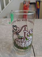 Front view showing Holly Hobbie illustration and Fill Your Day With Happiness text on glass