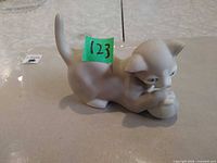 Full side view of porcelain cat figurine
