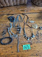 Full lot overview on wooden surface showing all jewelry pieces together