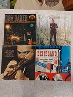 Four album covers: Don Baker organ, The Intimate Jim Reeves, Al Hirt trumpet, Dixieland Left Bank Bearcats