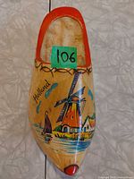 Top view of painted wooden clog with Holland windmill scene