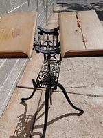 Overall view of music stand showing folding wooden panels and cast iron frame